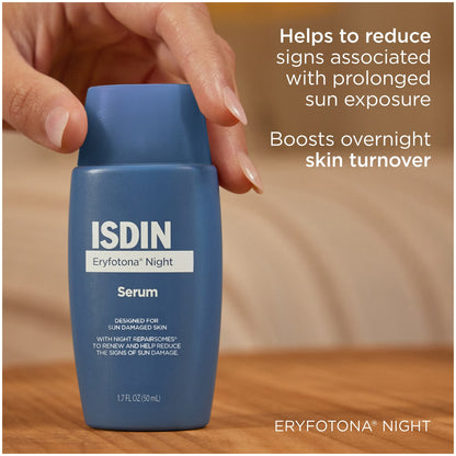 Blue serum bottle with ISDIN branding on a wooden surface
