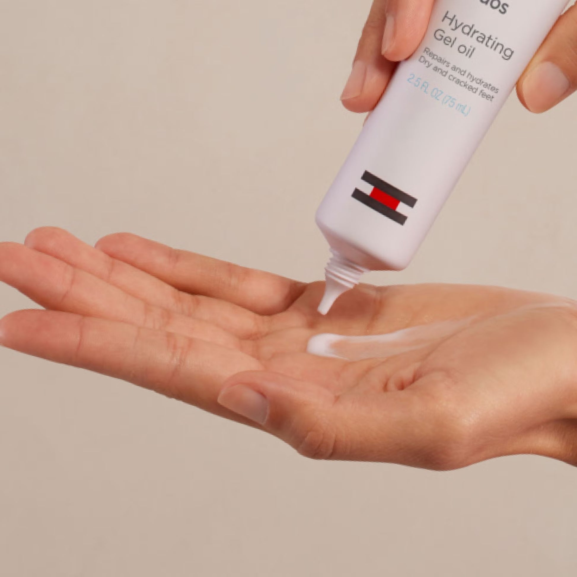 Hand applying a white gel from a bottle labeled 'Hanskin' on a beige background