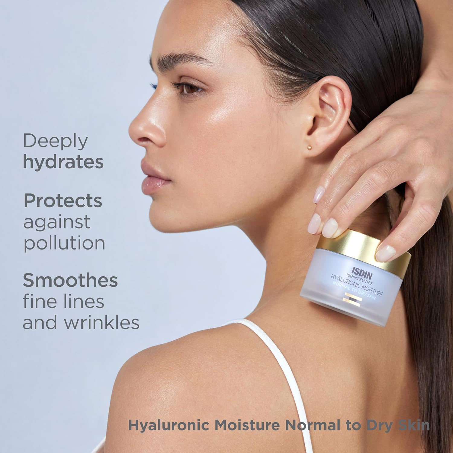 Woman holding a skincare product with text highlighting its benefits on a light gray background