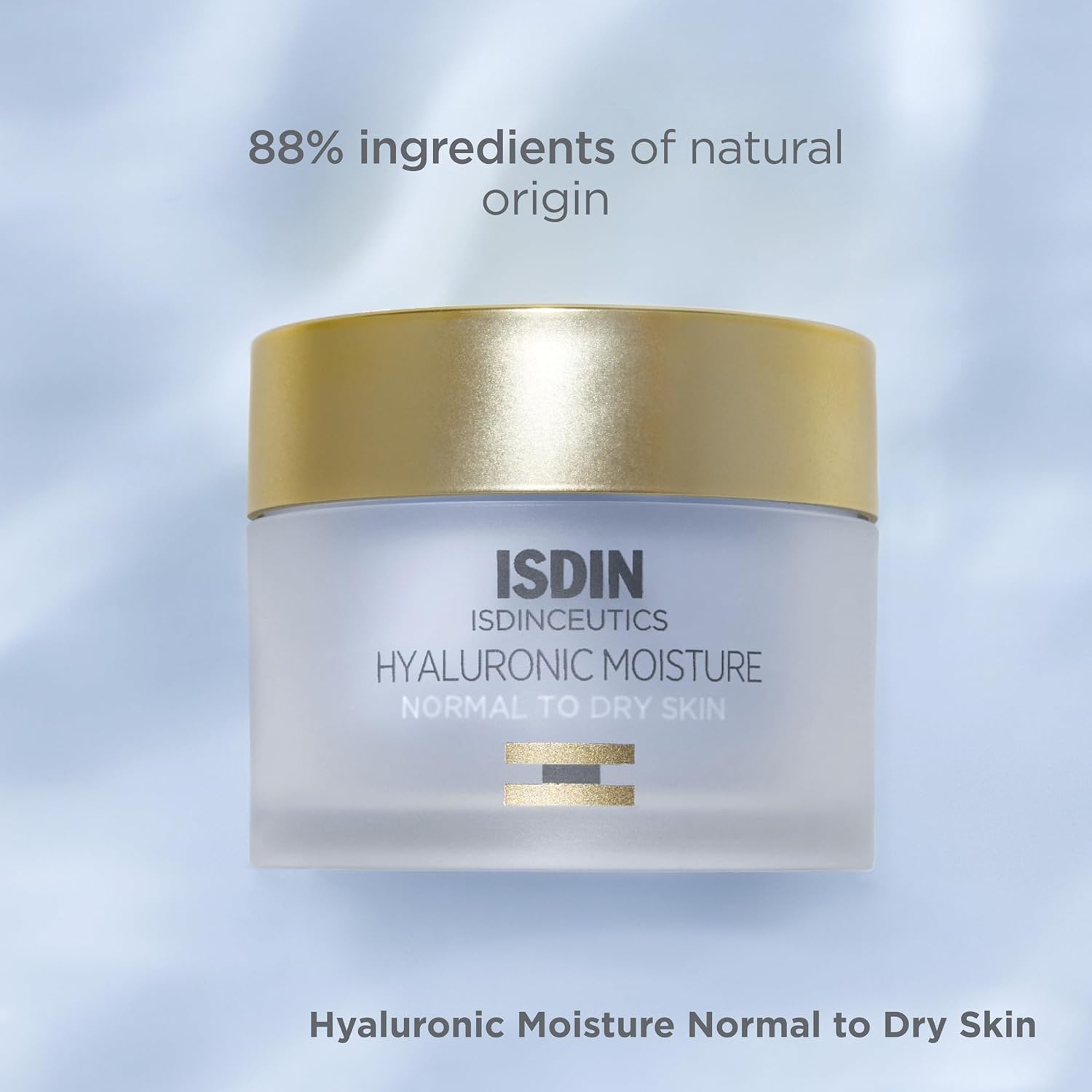 ISDIN cream jar with gold lid on a light blue background