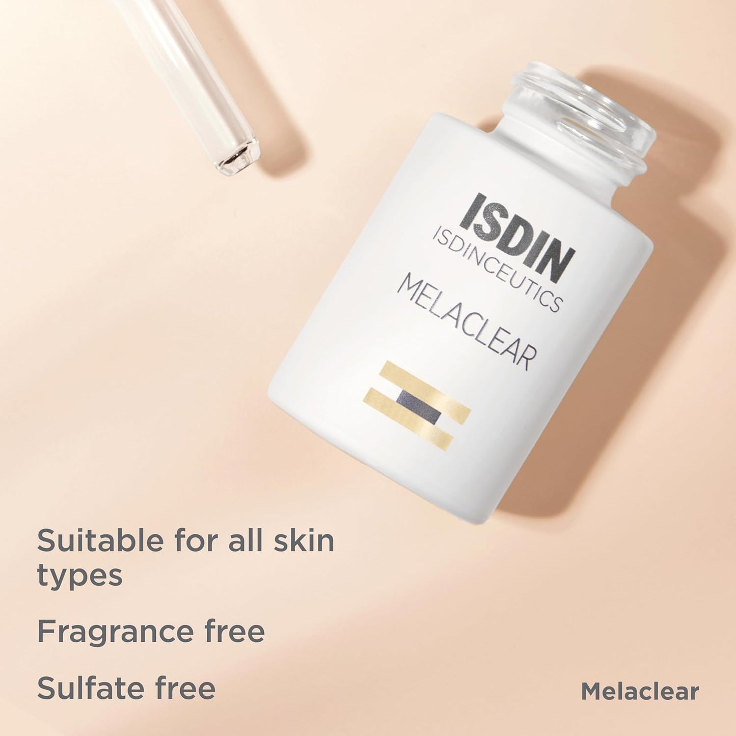 ISDIN Melaclear bottle on a beige background