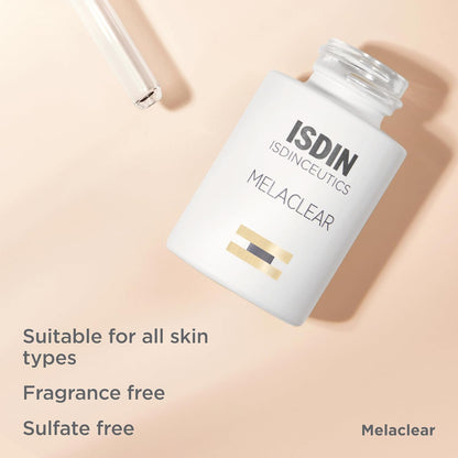 ISDIN Melaclear bottle on a beige background