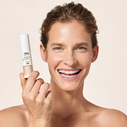Woman holding a skincare product against a beige background