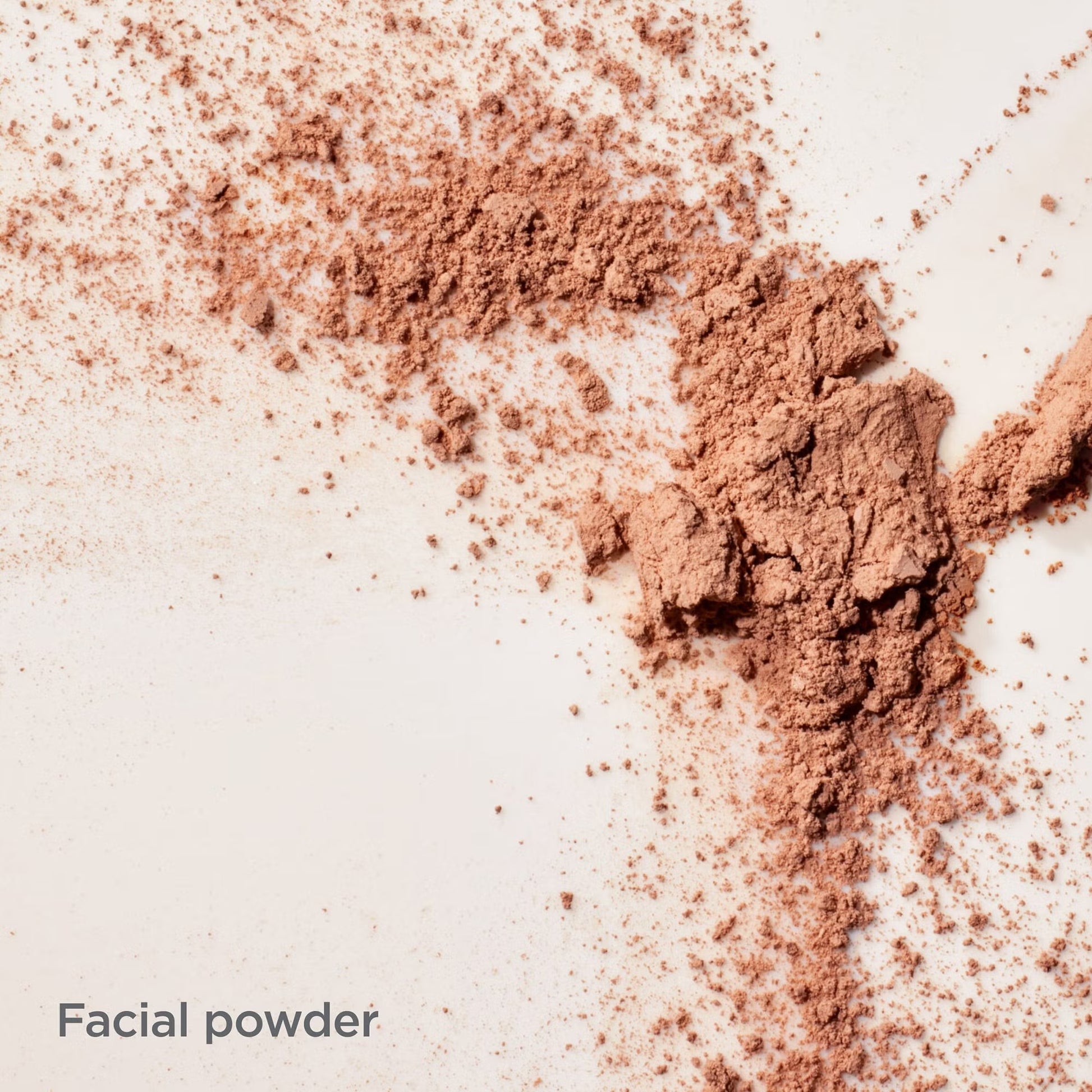 Close-up of brown facial powder on a light background