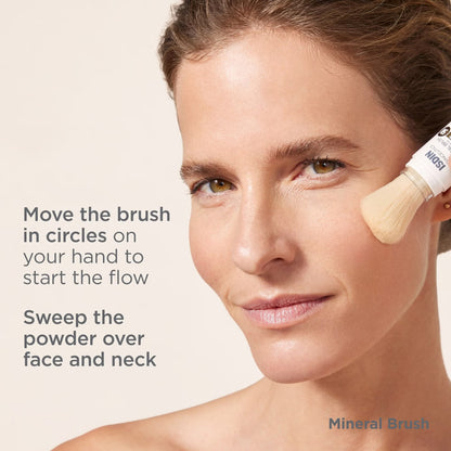 Woman applying powder with a brush on a beige background