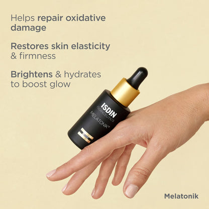 ISDIN Melatonik skincare serum bottle held by a hand on a beige background