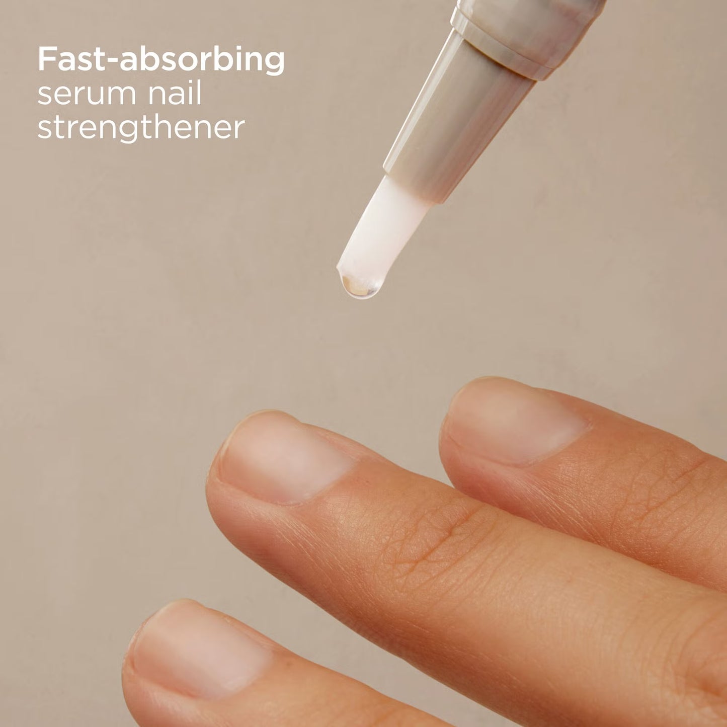 Fast-absorbing serum nail strengthener being applied to a finger with a beige background