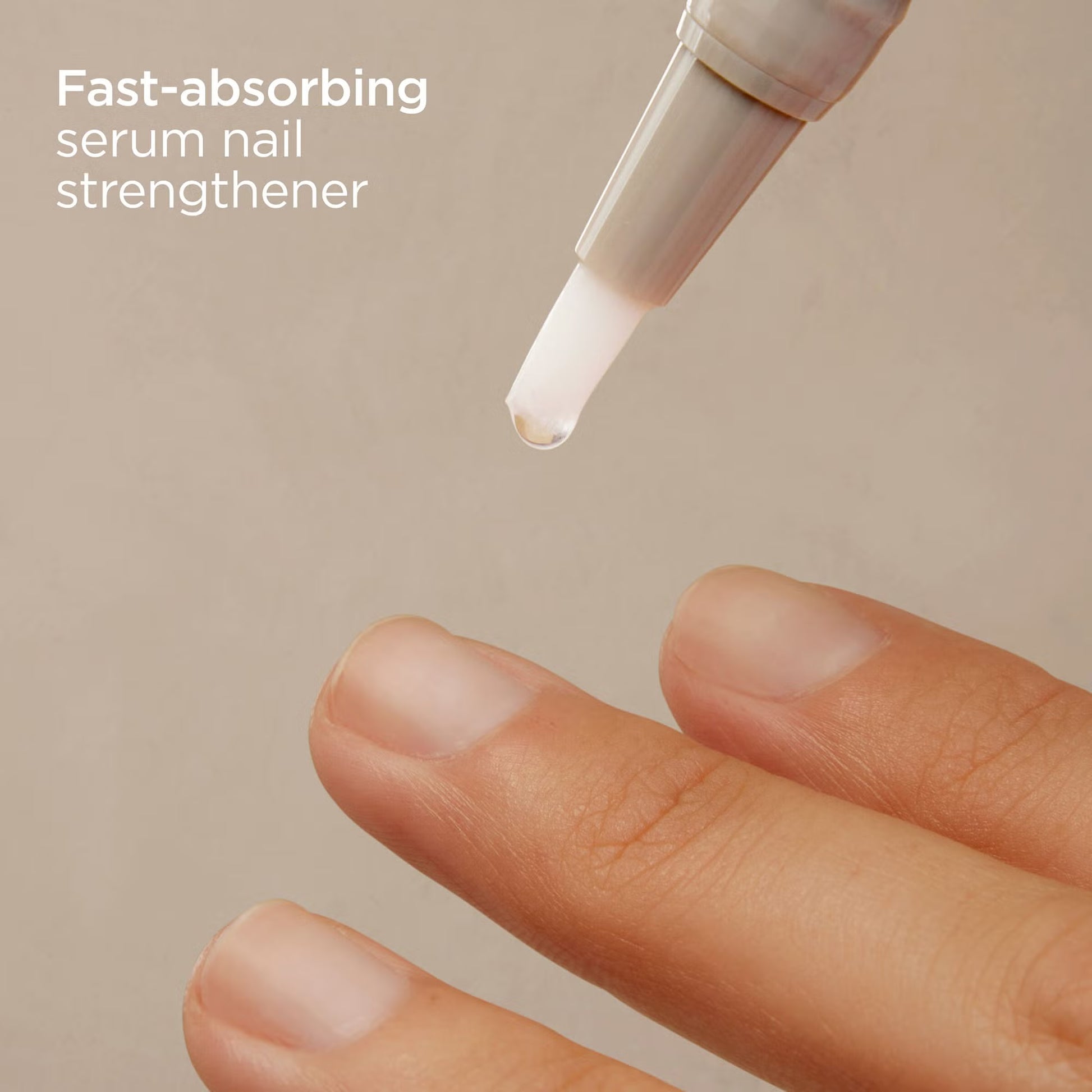 Fast-absorbing serum nail strengthener being applied to a finger with a beige background