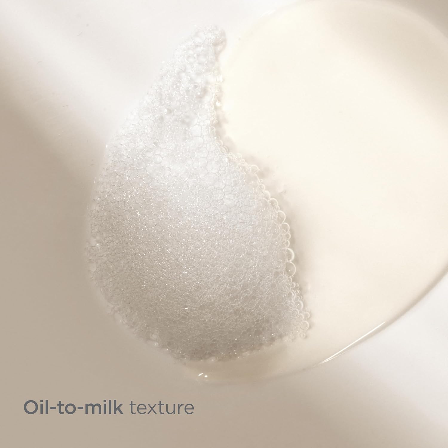 Oil-to-milk texture transition on a white background