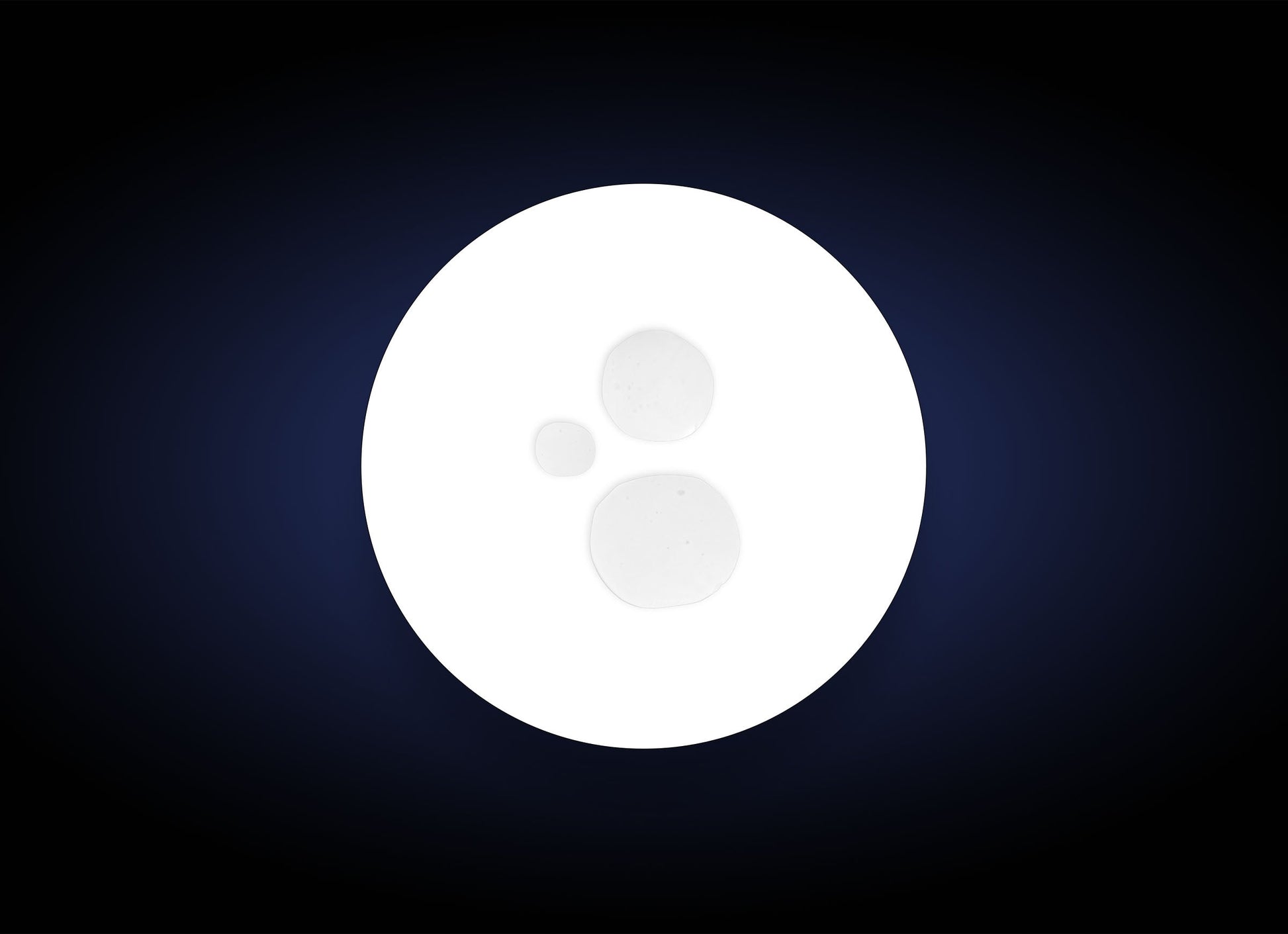 White circular object with a central dot on a dark blue background